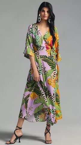 Lady posing in a jungle printed wrap dress and black strappy sandals