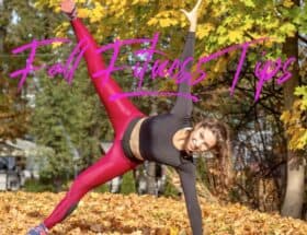 Lady doing a side plank in the leaves