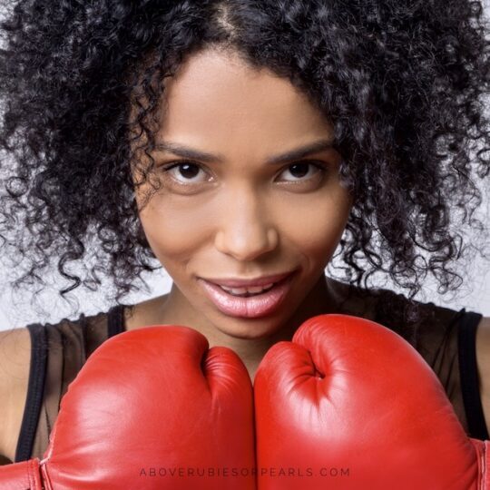 smiling lady wearing red boxing gloves