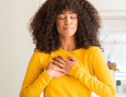 Lady with her hands over her heart in gratitude