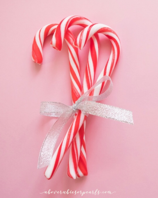3 candy canes tied with a silver ribbon