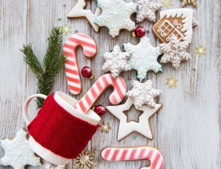 A display of Christmas cookies, candy canes, a Christmas mug and ornaments