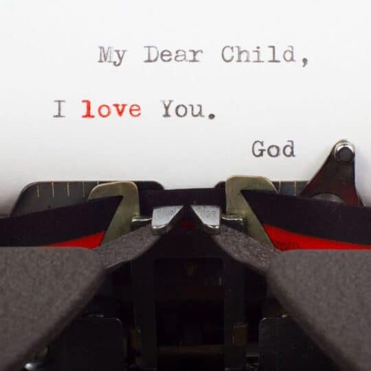 A page of paper in a typewriter is displayed with a message from God