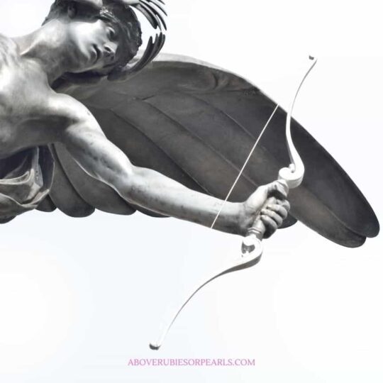 A statue of Eros before he evolved into Cupid, with a bow in one hand and wings on his back.