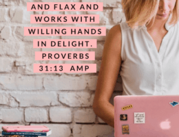 A Proverbs 31 Business Woman is working on her pink laptop. She is sitting on a hardwood floor, leaning against a white brick wall. She has a stack of books and other resources next to her, including a girl boss book.
