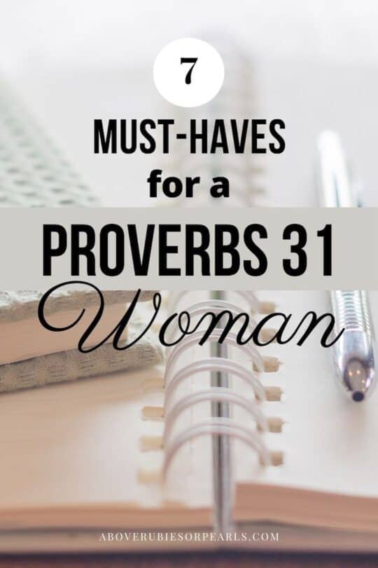 Proverbs 31 must-haves include items such as this quilted gray journal atop an open planner and a pen.