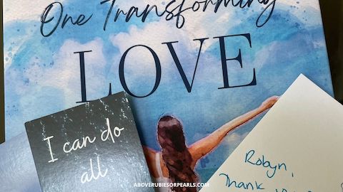 A copy of the book One Transforming Love, the bookmarks that came with it, and a note from the author.
