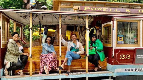 Four ladies on a San Francisco cable car