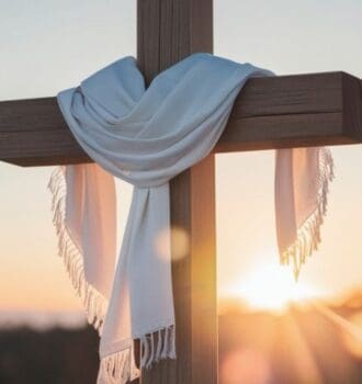 Wooden cross draped with a white cloth at sunrise, symbolizing true confidence in Christ through the Cross