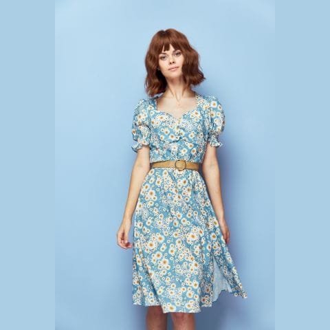 Modest spring fashion: woman wearing blue daisy-print dress and belt